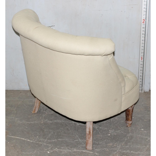 56 - An unusual button backed low tub chair with cream upholstery