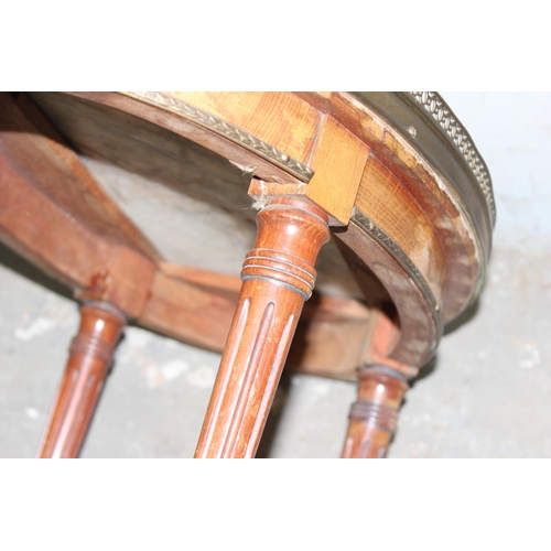 61 - A French Bouillotte table with marble top and brass gallery standing on fluted legs, likely 20th cen... 