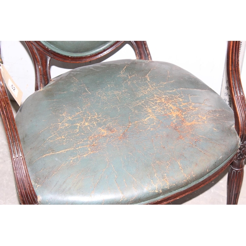 62 - An early 19th century shield backed armchair with dark green leather upholstery