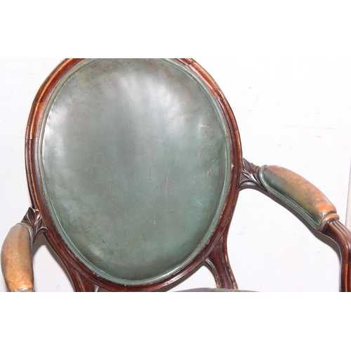 62 - An early 19th century shield backed armchair with dark green leather upholstery