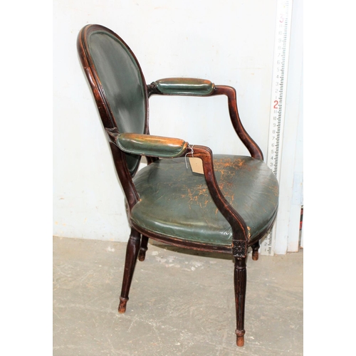 62 - An early 19th century shield backed armchair with dark green leather upholstery