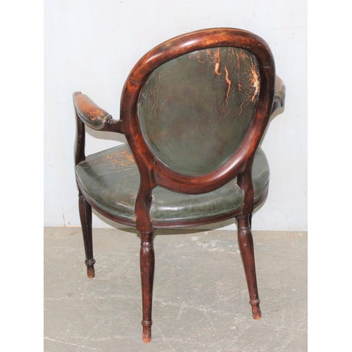 62 - An early 19th century shield backed armchair with dark green leather upholstery