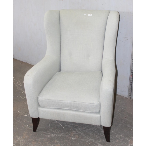 69 - A modern wingback armchair with light grey upholstery