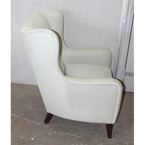 69 - A modern wingback armchair with light grey upholstery