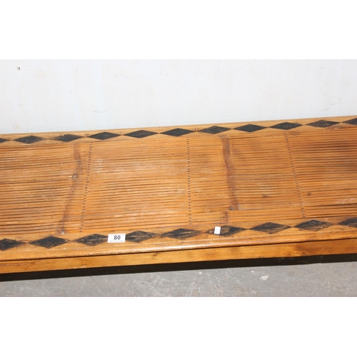 80 - A long slatted wooden window seat with geometric decoration, approx 150cm wide