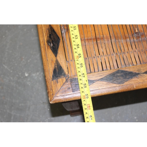 80 - A long slatted wooden window seat with geometric decoration, approx 150cm wide