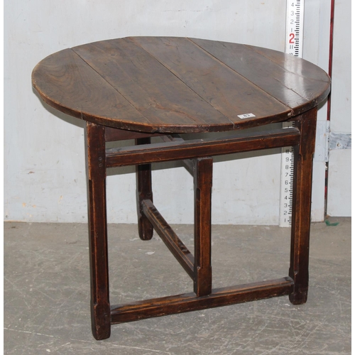 83 - An antique elm table with unusual folding base, believed to be 18th century or earlier