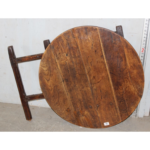 83 - An antique elm table with unusual folding base, believed to be 18th century or earlier