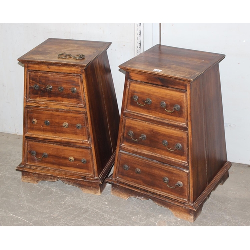 85 - A pair of triangular prism shaped bedside tables with 3 drawers and drop handles. all handles presen... 