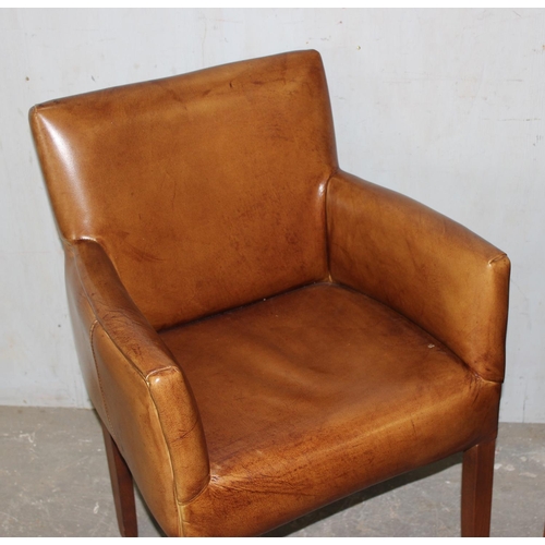 88 - A pair of tan leather carver armchairs with wooden legs, likely John Lewis