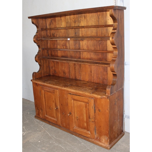 15 - A large antique pine kitchen dresser of unusual form, likely 19th century, approx 155cm wide x 180cm... 