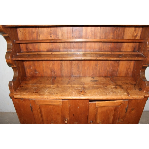 15 - A large antique pine kitchen dresser of unusual form, likely 19th century, approx 155cm wide x 180cm... 