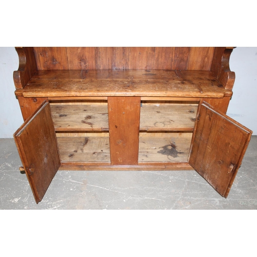 15 - A large antique pine kitchen dresser of unusual form, likely 19th century, approx 155cm wide x 180cm... 