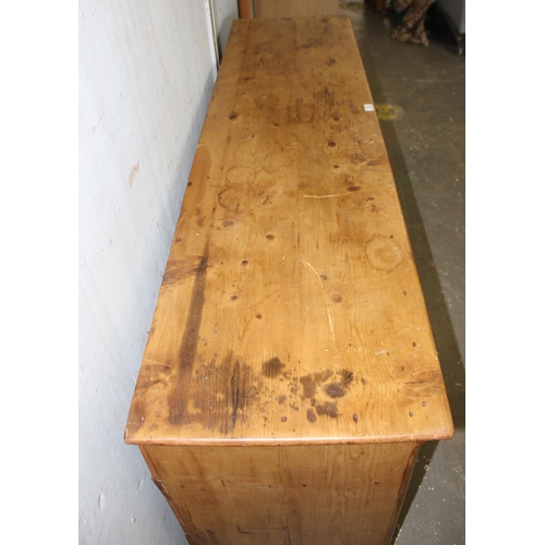 16 - A Victorian pine dresser base or sideboard with 3 central drawers flanked by 2 cupboards and 2 drawe... 