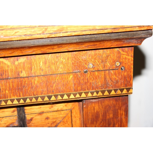 18 - An antique light oak bookcase with parquetry inlay, approx 120cm wide, on later bespoke made stand