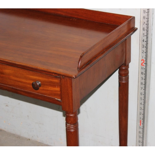 19 - A small antique mahogany desk with 2 drawers, approx 92cm wide