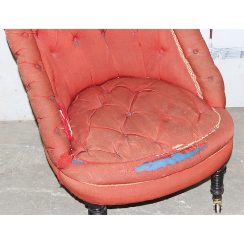 22 - A Victorian button backed nursing chair with ebonised legs and brass & ceramic castors