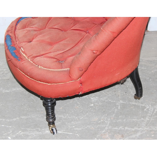 22 - A Victorian button backed nursing chair with ebonised legs and brass & ceramic castors