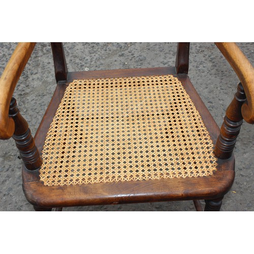 34 - A very well turned bobbin framed antique arm chair with bergere seat