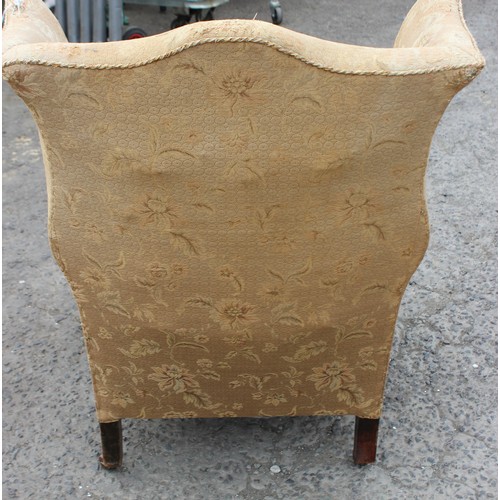 91 - An antique wing back arm chair with sprung seat, horse hair stuffing and good ceramic castors