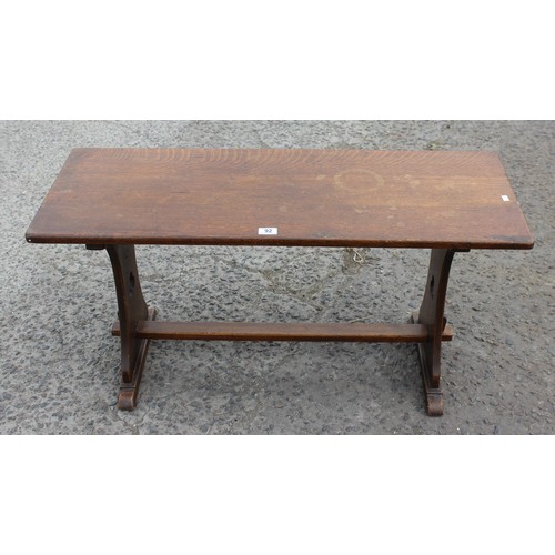 92 - An oak coffee table with carved clover detail