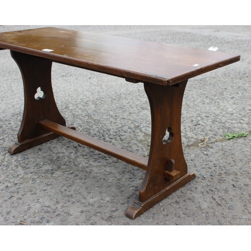 92 - An oak coffee table with carved clover detail