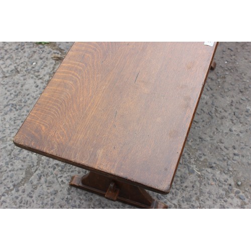 92 - An oak coffee table with carved clover detail