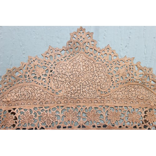 499a - An Islamic copper easel stand table top mirror with bevelled glass.