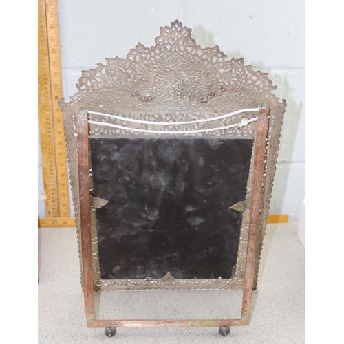 499a - An Islamic copper easel stand table top mirror with bevelled glass.