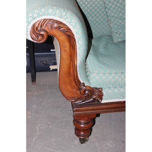 142 - A 19th century mahogany scroll arm sofa with brass cup castors, later green upholstery with matching... 