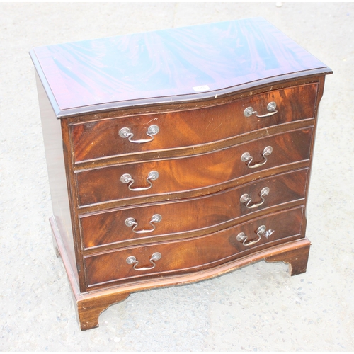 148 - A 20th century mahogany effect serpentine 4 drawer chest of drawers