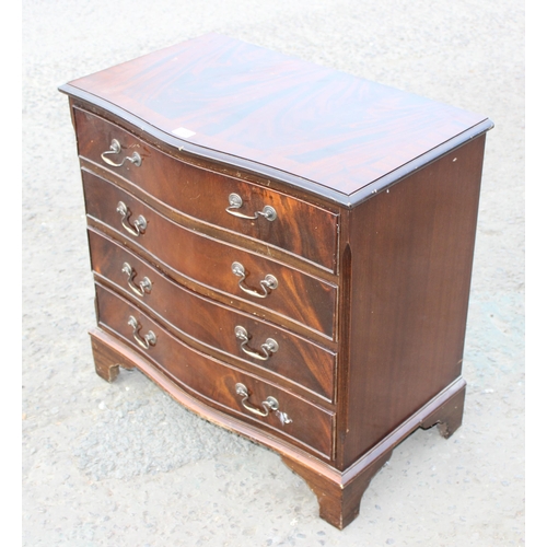 148 - A 20th century mahogany effect serpentine 4 drawer chest of drawers