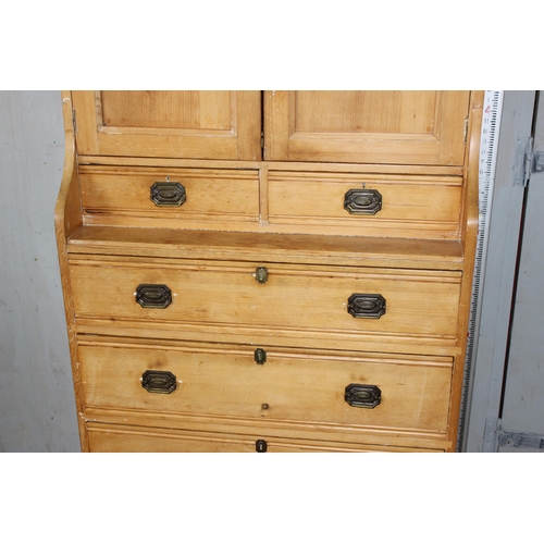 1 - An unusual Victorian pine cupboard consisting of 4 drawers under 2 smaller drawers under a small cup... 