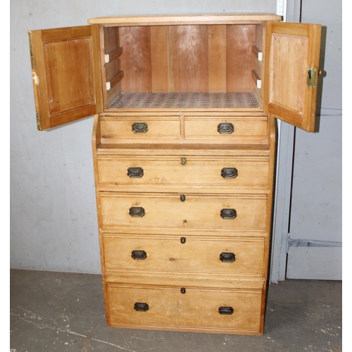 1 - An unusual Victorian pine cupboard consisting of 4 drawers under 2 smaller drawers under a small cup... 