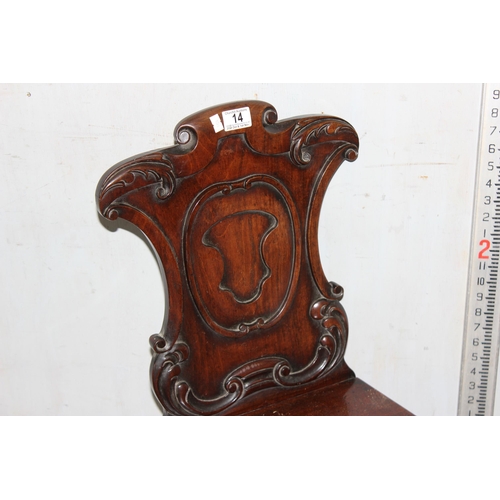 14 - A 19th century mahogany hall chair with carved back