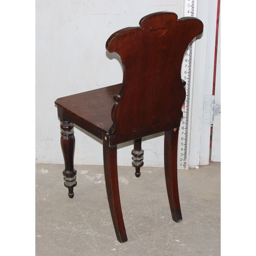 14 - A 19th century mahogany hall chair with carved back