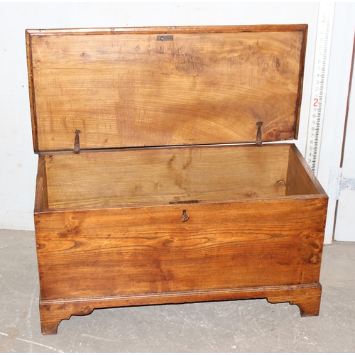 18 - An antique elm coffer with original iron key and bracket fee, approx 95cm wide