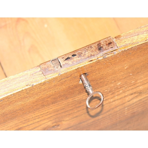 18 - An antique elm coffer with original iron key and bracket fee, approx 95cm wide