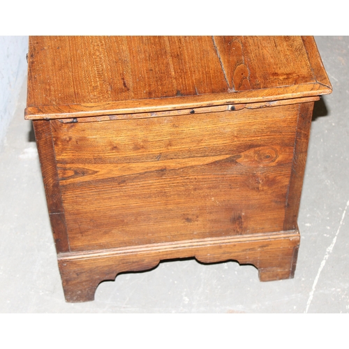 18 - An antique elm coffer with original iron key and bracket fee, approx 95cm wide