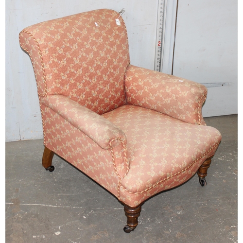 3 - A 19th century deep seated armchair with salmon coloured floral patterned upholstery, standing on tu... 