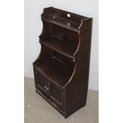 36 - Darkwood waterfall bookcase with cabinet base, likely Ercol