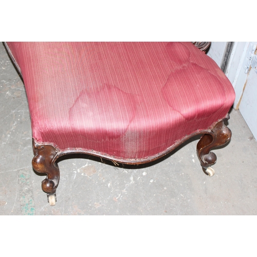 49 - A Victorian mahogany framed button backed chaise longue with rouge upholstery and brass and ceramic ... 