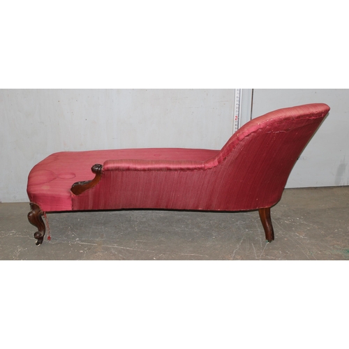 49 - A Victorian mahogany framed button backed chaise longue with rouge upholstery and brass and ceramic ... 