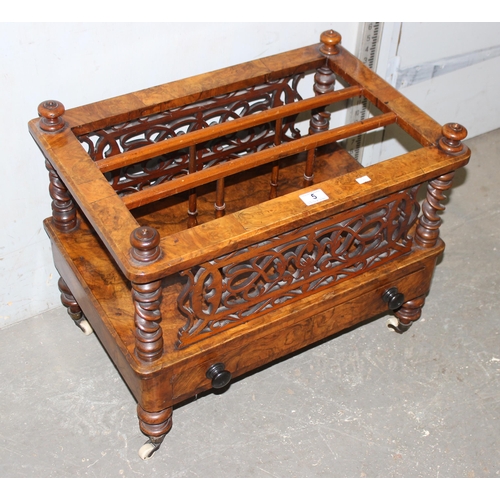 5 - An antique walnut canterbury or magazine rack, 19th century with brass and ceramic castors and fretw... 