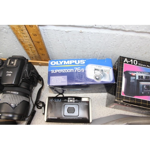 650 - 2 boxes of assorted cameras and accessories, mainly digital to inc Fujifilm S9500, Olympus Superzoom... 