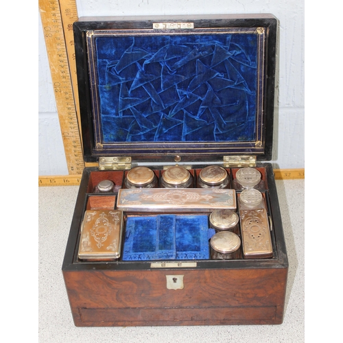 283 - An antique walnut vanity box with extensive contents with silver plated lids and 2 hidden compartmen... 