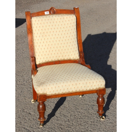 138A - A 19th century Victorian chair with cream upholstered seat and brass and ceramic castors