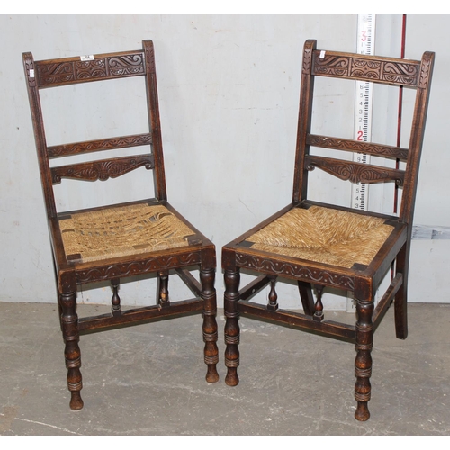 159 - A pair of antique carved oak chairs with rush seats