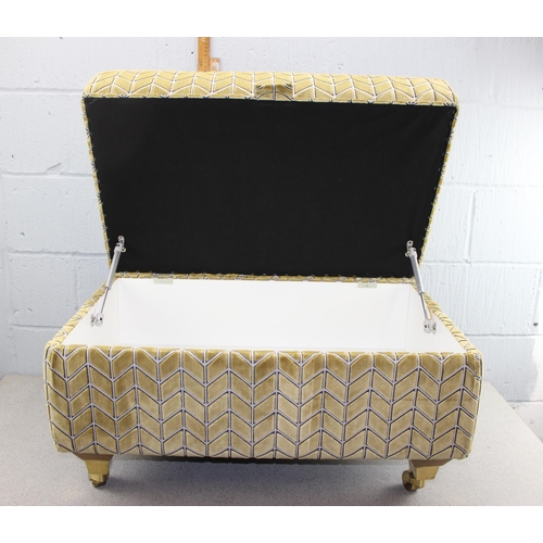 145 - Karki coloured fabric Ottoman on brass castors