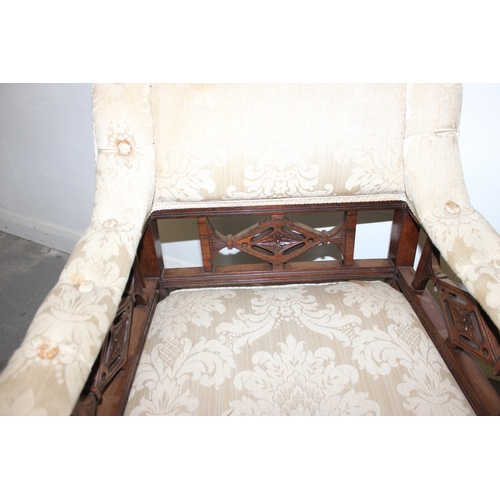 149 - An unusual late Victorian Rosewood ladies armchair with castors